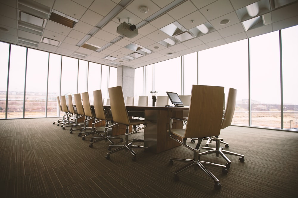 An empty boardroom with glass-to-ceiling windows