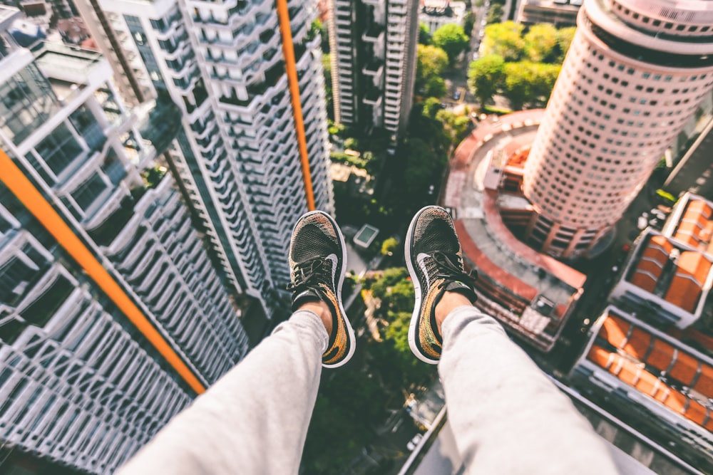 aerial view of man's feet and city buildings