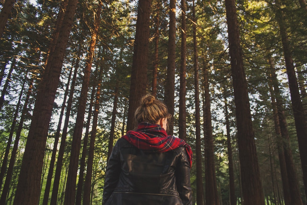 woman wearing black jacket looking at trees