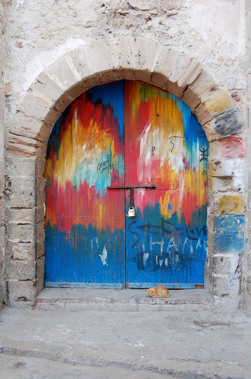 Una puerta redondeada pintada de colores.