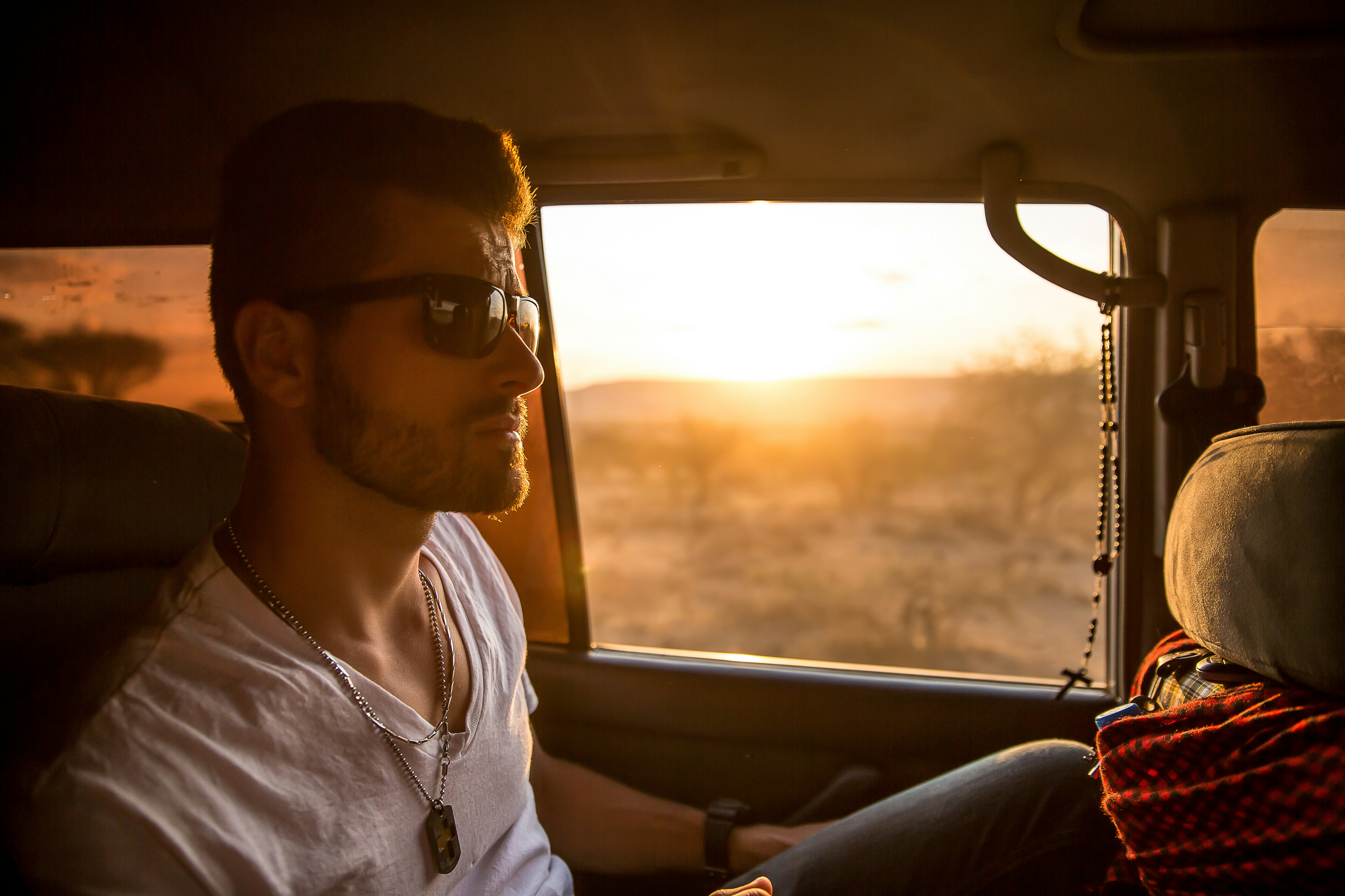 Man in car sunset