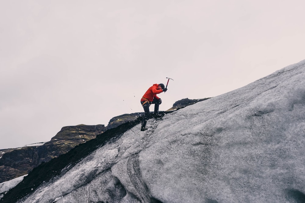 man climbing on mountain during daytime