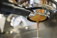 Latte dripping from a coffee machine