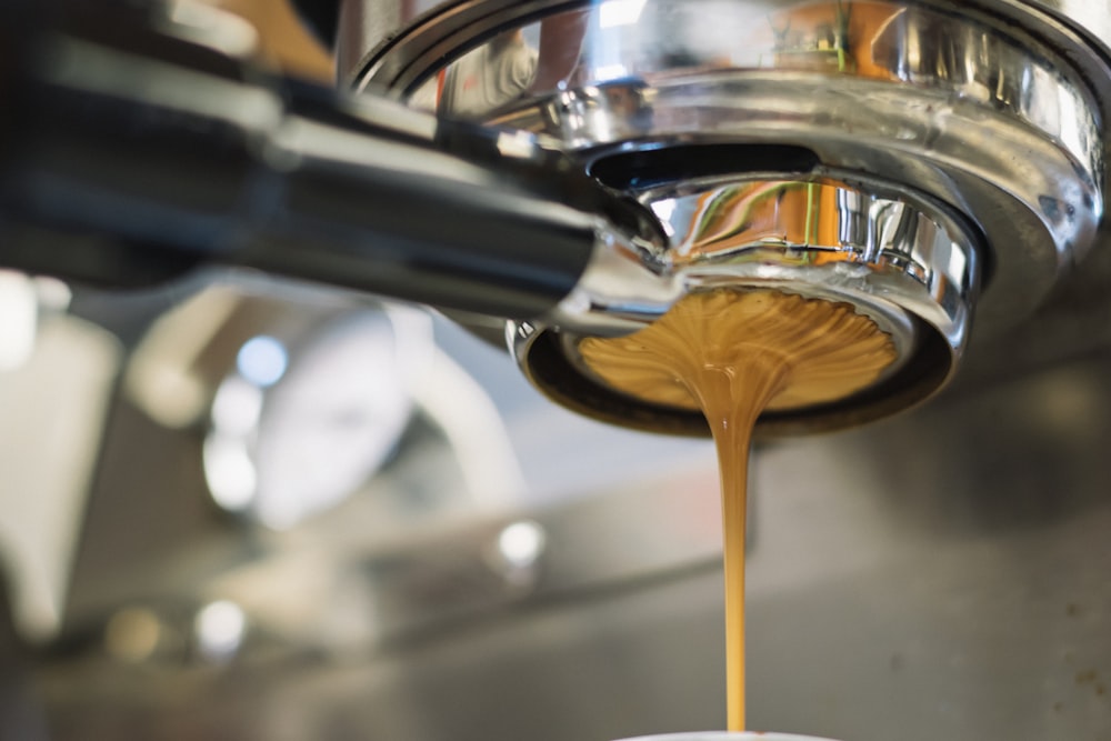 Latte dripping from a coffee machine