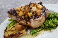 grilled steak with vegetables on white ceramic plate