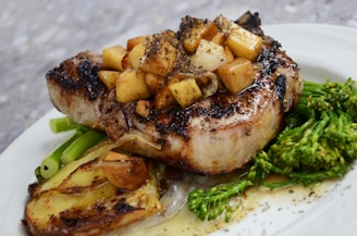 grilled steak with vegetables on white ceramic plate