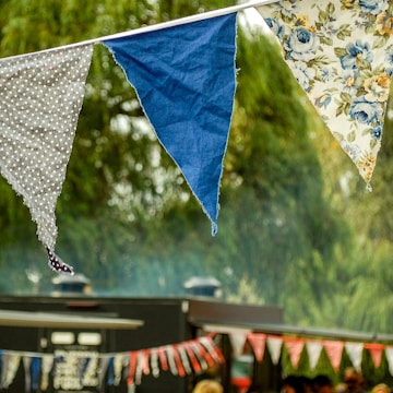 Close-up of a colorful custom banner hanging at a busy event.