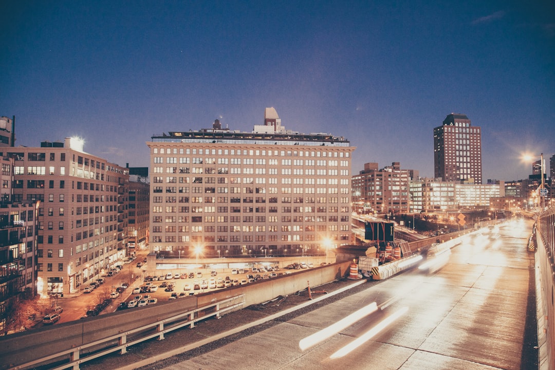 time lapse photography of vehicles near building