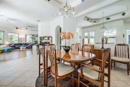 Open-plan living space flooded with natural light, featuring warm beige tones and elegant furnishings.