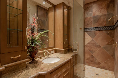 Bathroom with marble countertops and a rainfall shower in the luxury room.
