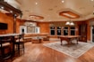billiard table in center of brown painted room