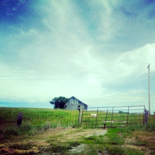 Rustic barn on a large plot of rural land with open skies.