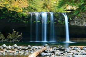 long-exposure photo of lake with waterfall at daytime