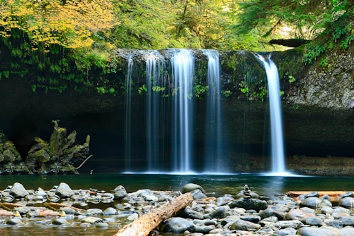 long-exposure photo of lake with waterfall at daytime