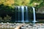 long-exposure photo of lake with waterfall at daytime