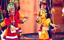 selective focus photography of deity marionettes