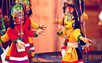 selective focus photography of deity marionettes