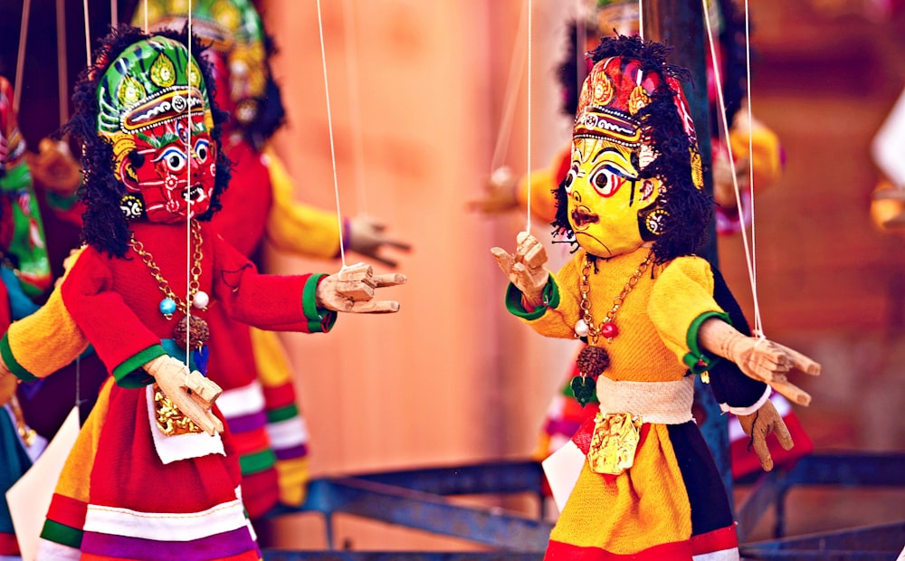 selective focus photography of deity marionettes