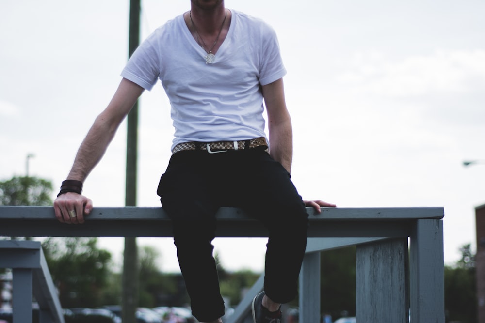 man sitting on balustrade