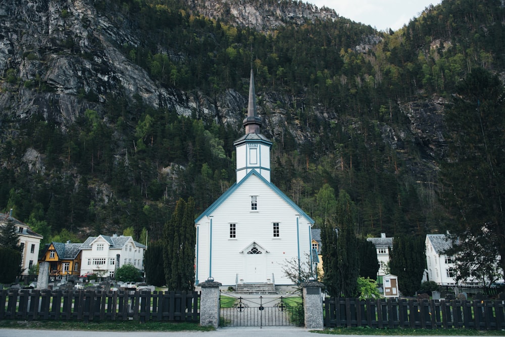 white and blue castle in front of mountain