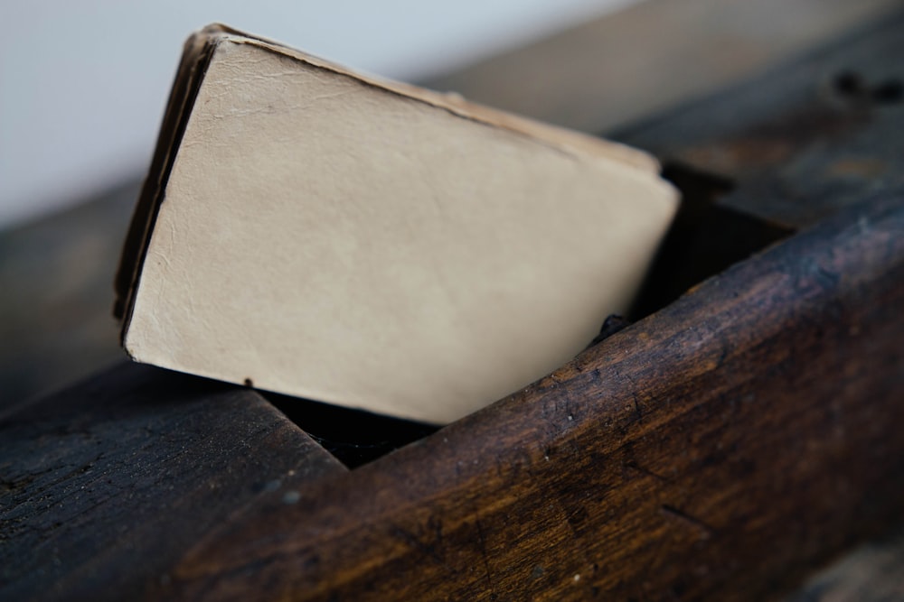 brown cards on brown wooden surface closeup photography