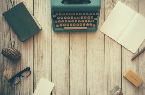 vintage teal typewriter beside book