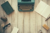 vintage teal typewriter beside book