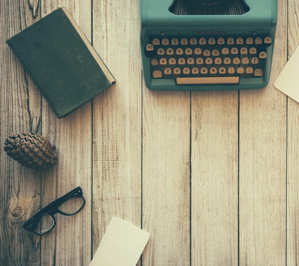 vintage teal typewriter beside book