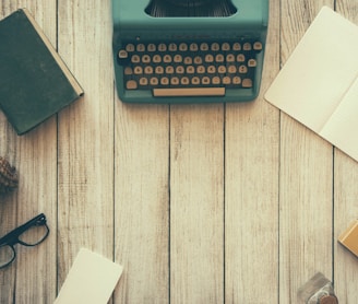 vintage teal typewriter beside book