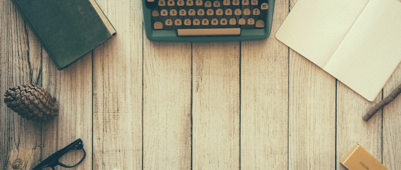 vintage teal typewriter beside book