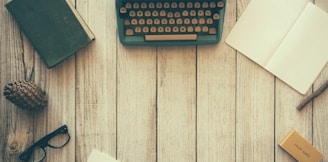 vintage teal typewriter beside book