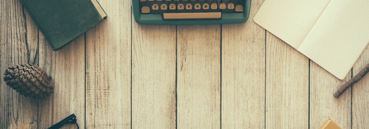 vintage teal typewriter beside book