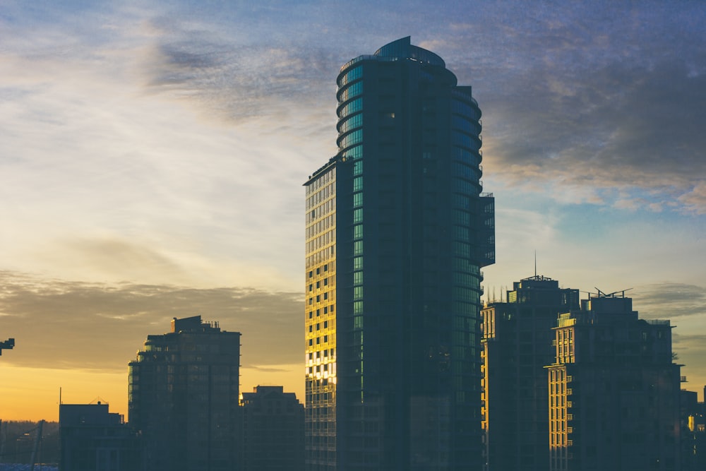 city buildings under cloudy sky during sunset