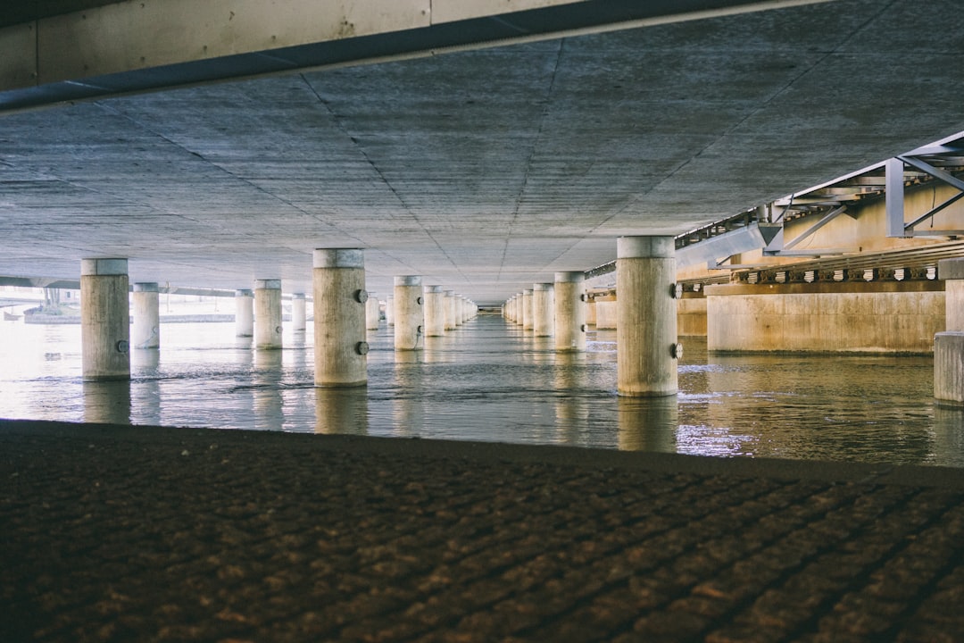 white pillars supporting concrete roof