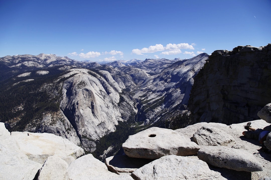 rock mountains under blue and cloudy sky during daytime photography