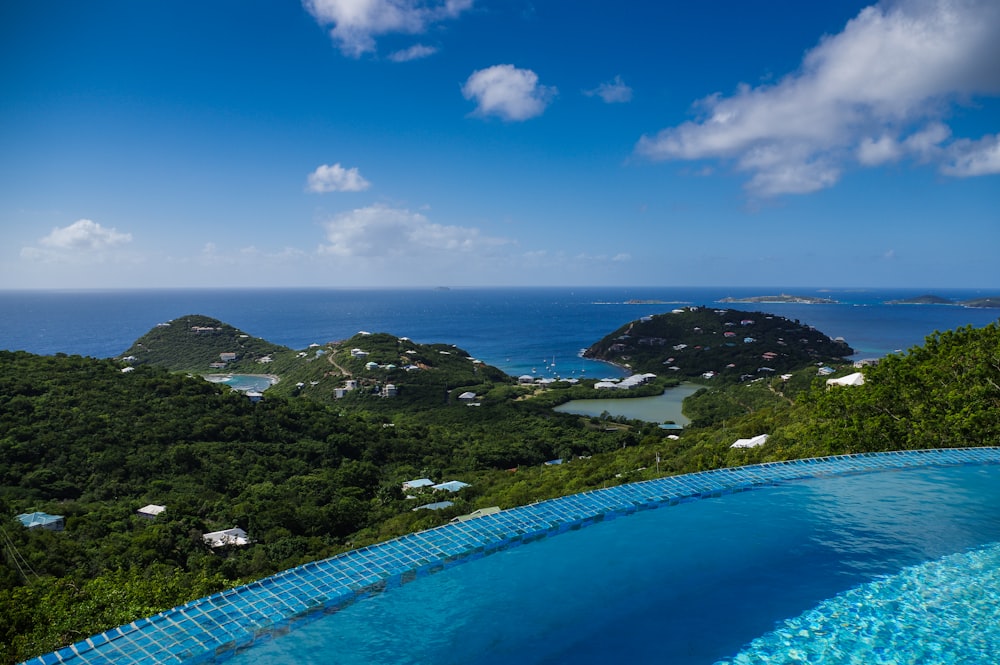 bird's eye view photography of pool on ridge near body of water