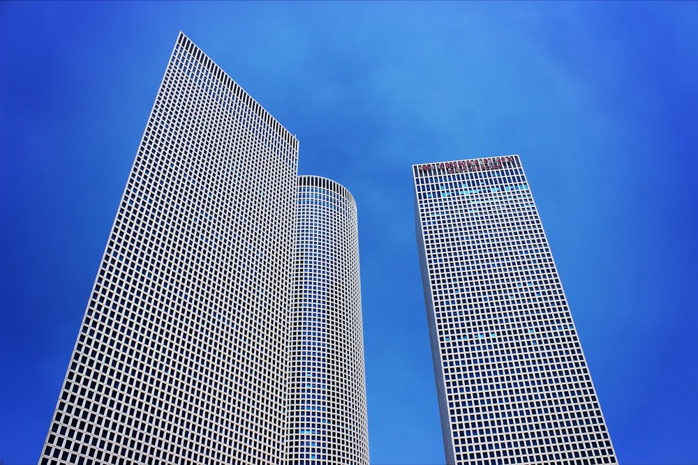 low-angle photography of three high-rise buildings