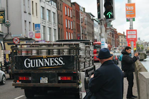 A Barry Quinn Transport truck equipped with fuel-efficient technology driving along a scenic Irish countryside road.