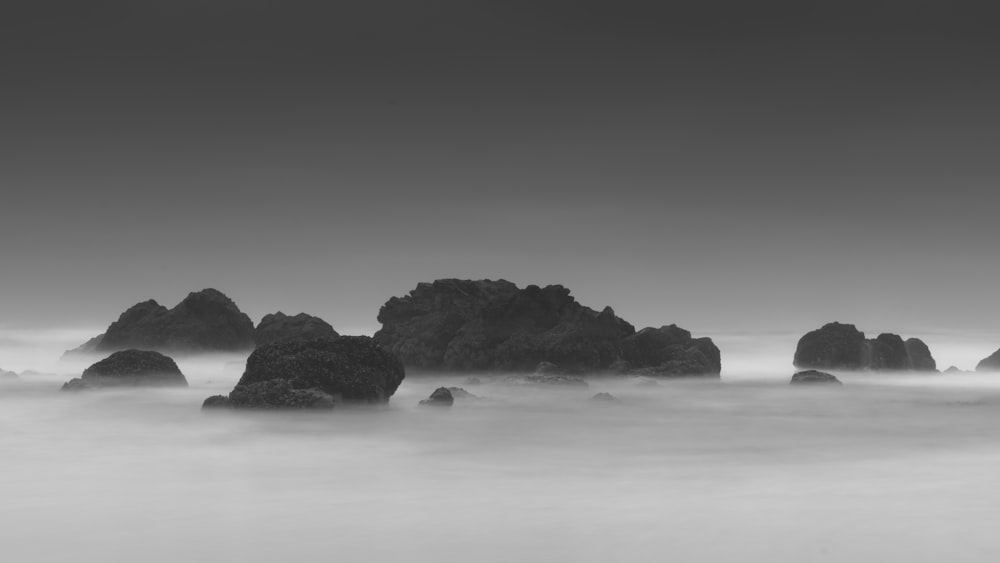 grayscale photography of rock formations