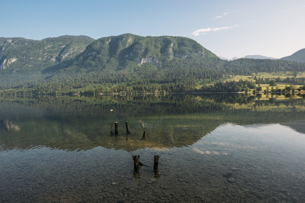 lake viewing mountain under blue and white skies