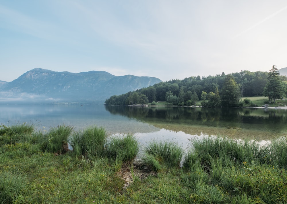 photo of lake across mountain during daytime