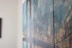 Close-up of a textured cityscape painting showing palette knife and sponge details.