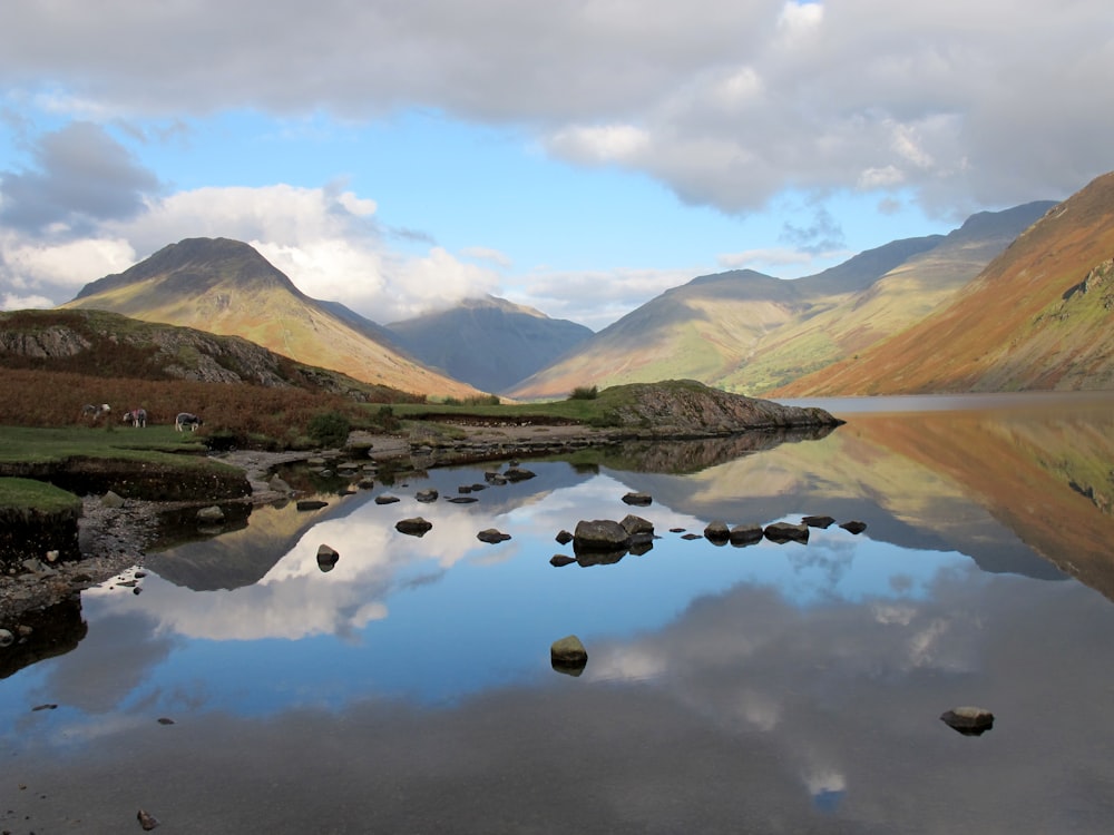 body of water surrounded with mountains