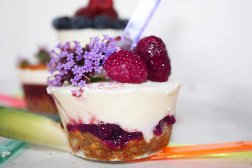 A colorful dessert featuring fresh berries and creamy layers, beautifully plated.