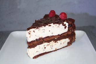 Close-up photo of a moist banana sponge cake filled with rich chocolate cream, beautifully plated with a rustic background.
