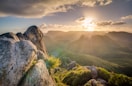 Sunrise above the mountains with glowing clouds, symbolizing a new beginning and gentle self-healing