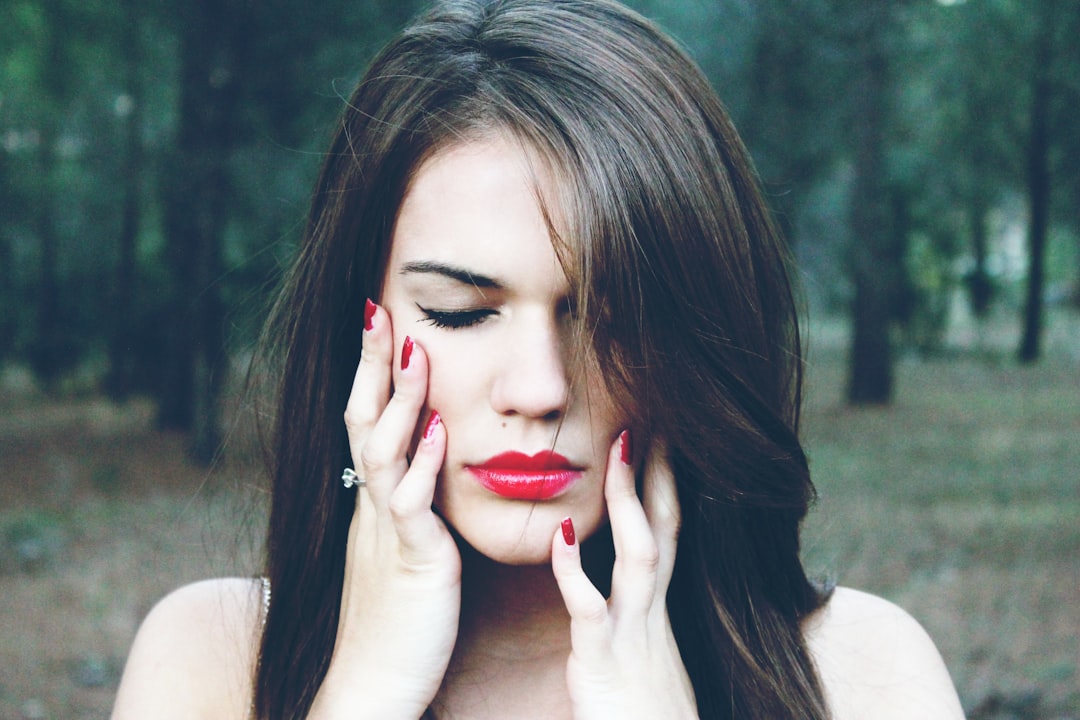 woman holding her face