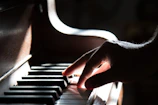 Close-up of Mauro Lionel playing piano with intense focus on stage.