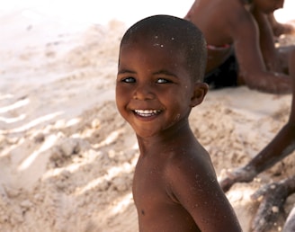 Children playing on the sandy shore near Ponto Beach with smiles and laughter.