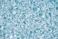 a pool with clear blue water and bubbles